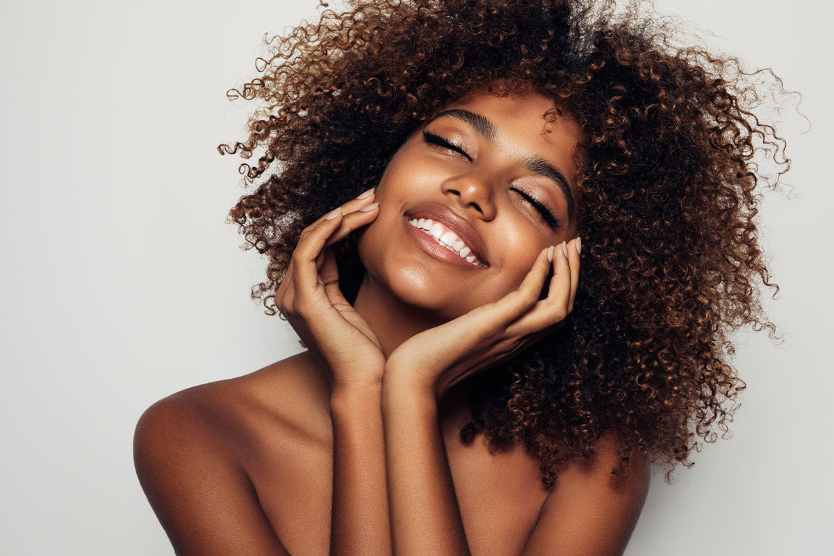 Smiling woman with smooth skin after dermal fillers in Redlands